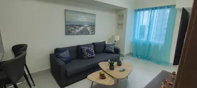 a living room with a couch and two tables at Boca del Mar III, Boca Chica in Boca Chica