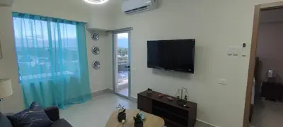 a living room with a flat screen tv on the wall at Boca del Mar III, Boca Chica in Boca Chica