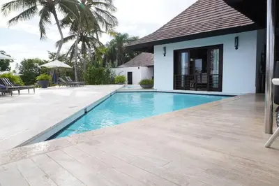 a swimming pool in front of a villa at Villa Alpes, Exquisite Retreat In Casa De Campo in La Romana