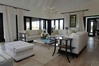 a living room with white furniture and a chandelier at Villa Alpes, Exquisite Retreat In Casa De Campo in La Romana