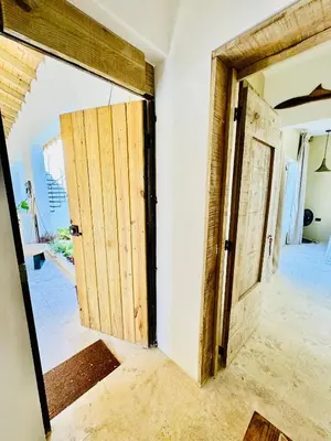 an open room with two doors in a house at Suami s room Casa Padura in Cabarete
