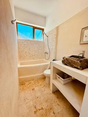 a bathroom with a tub and a toilet and a sink at Suami s room Casa Padura in Cabarete