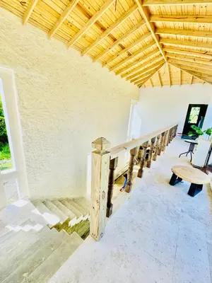 a room with stairs and a wooden ceiling at Suami s room Casa Padura in Cabarete