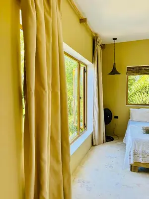 a bedroom with a bed and a window at Suami s room Casa Padura in Cabarete