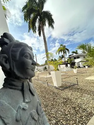 a statue of a girl on a beach with palm trees at Level suites #2 platinum in Sosúa
