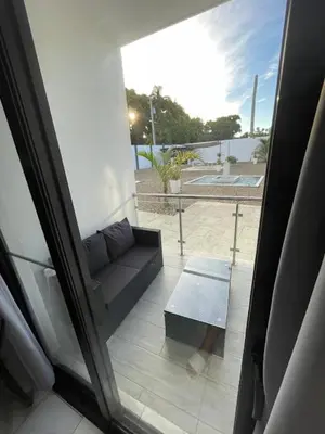 a view of a balcony with a couch and a table at Level suites #2 platinum in Sosúa