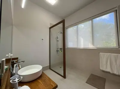 a bathroom with a sink and a shower and a mirror at Villa Pradera, Upscale Comfort In Casa De Campo in La Romana