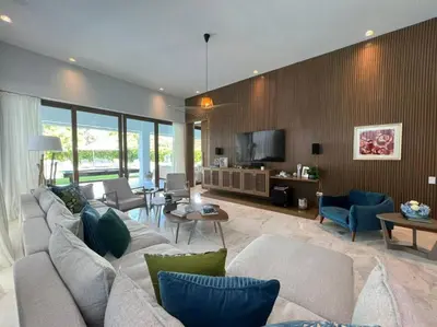 a living room with a couch and a tv at Villa Pradera, Upscale Comfort In Casa De Campo in La Romana