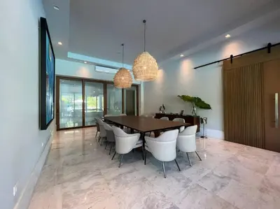 a dining room with a table and white chairs at Villa Pradera, Upscale Comfort In Casa De Campo in La Romana