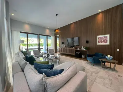 a living room with a large couch and chairs at Villa Pradera, Upscale Comfort In Casa De Campo in La Romana