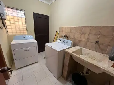 a bathroom with a washing machine and a sink at Central Oasis Work or Explore the city in Santo Domingo