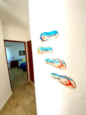 a wall with several decals on it in a bedroom at The Best Place in los Corales RD Arenas De B in Punta Cana