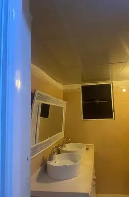 a bathroom with two sinks and a window at River 1 Basili in Santa Bárbara de Samaná