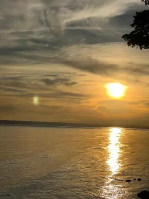a sunset over a body of water with the sun at River 1 Basili in Santa Bárbara de Samaná