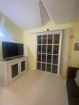 a living room with a television and a couch at River 1 Basili in Santa Bárbara de Samaná