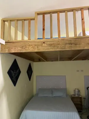 a bunk bed in a room with a wooden bunk bedweredotentotent at Ático riomar segundo piso in Santa Bárbara de Samaná