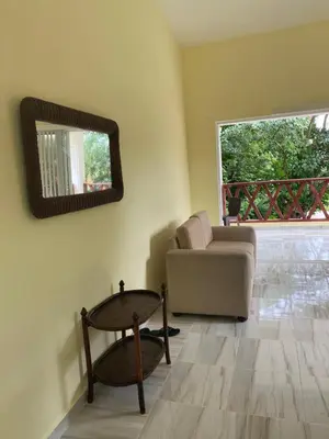 a living room with a couch and a table and a mirror at Ático riomar segundo piso in Santa Bárbara de Samaná