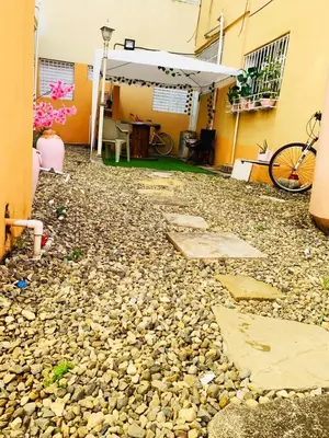 a backyard with rocks and a table and a bike at Tropical Estudio En El Centro De La Ciudad in San Felipe de Puerto Plata