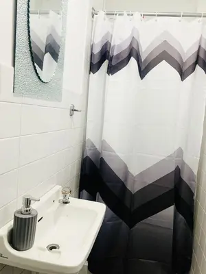 a bathroom with a sink and a shower curtain at Tropical Estudio En El Centro De La Ciudad in San Felipe de Puerto Plata