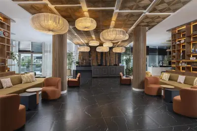 a lobby with couches and chairs and chandeliers at Hyatt Centric Santo Domingo in Santo Domingo