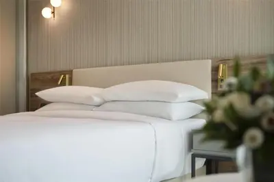 a white bed with white pillows on top of it at Hyatt Centric Santo Domingo in Santo Domingo