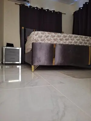 a bed in a room next to a black curtain at Mi Refugio in San Fernando de Monte Cristi