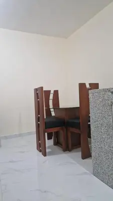a wooden table and chairs in a room at Mi Refugio in San Fernando de Monte Cristi