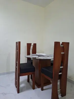 a wooden table with two chairs and a table and a table and chairsuggest at Mi Refugio in San Fernando de Monte Cristi