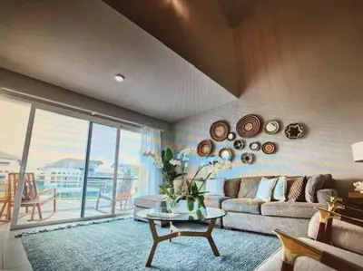 a living room with a couch and a table at New loft duplex with rooftop deck in La Laguna