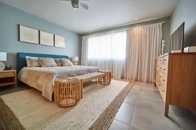 a bedroom with a bed and a dresser and a television at New loft duplex with rooftop deck in La Laguna
