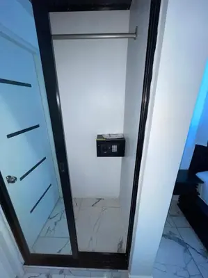 a glass door with a mirror in a room at LEVEL suites #4 OMEGA in Sosúa