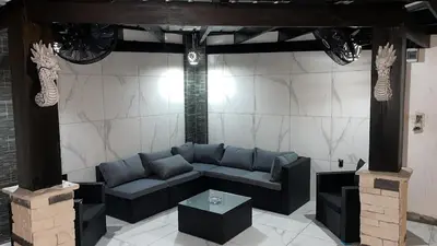 a living room with a couch and a table at LEVEL suites #4 OMEGA in Sosúa