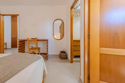 a bedroom with a bed and a mirror and a table at la maguana - cozy and beautiful 3BR home with pool in Santiago de los Caballeros