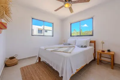 a bedroom with a bed with a ceiling fan at la maguana - cozy and beautiful 3BR home with pool in Santiago de los Caballeros