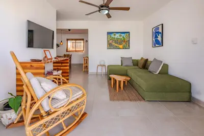 a living room with a green couch and a table at la maguana - cozy and beautiful 3BR home with pool in Santiago de los Caballeros