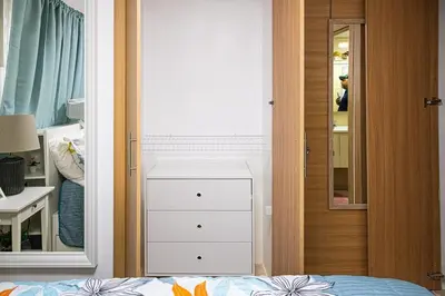 a bedroom with a dresser and a mirror at Europeo tropical in La Javilla