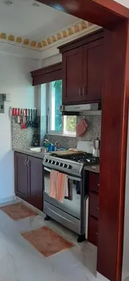 a kitchen with a stove and a sink at La casa de Marcel et Nathalie in Baní