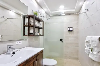 a bathroom with a shower and a sink and a toilet at Las Olas, Juan Dolio 2bed2bath Condo in Guayacanes
