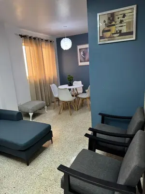 a living room with a couch and chairs and a table at Departamento en el centro in Santiago de los Caballeros