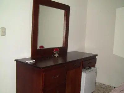 a wooden dresser with a mirror on top of it at Castillo Romano in Las Terrenas