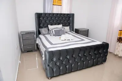 a large black bed with two stuffed animals on it at Luxury Aparment Bonao in Bonao