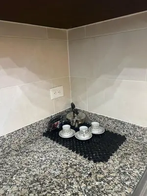 a counter with three coffee cups on top of it at Luxury Aparment Bonao in Bonao
