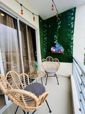 a porch with chairs and a table and a painting at Luxury Aparment Bonao in Bonao
