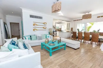 a living room with white furniture and a blue table at Penthouse frente al mar Playa Las Ballenas in Las Terrenas