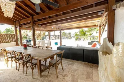 a dining room with a wooden table and chairs at Penthouse frente al mar Playa Las Ballenas in Las Terrenas