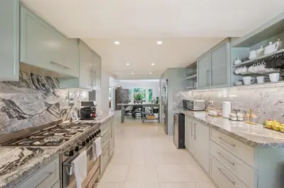a large kitchen with marble counter tops and stainless steel appliances at Cozy Private Family Villa at Casa de Campo - Pool, BBQ, Golf Cart in La Romana