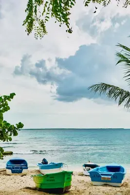 a group of boats sitting on the beach at Serene Beach Apartment in La Romana