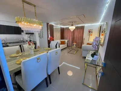 a kitchen and living room with a table and chairs at Apartamento con terraza y jacuzzi privado in Santo Domingo