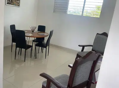 a dining room with a table and chairs at Habitación económica in Santiago de los Caballeros