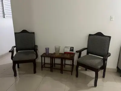 two chairs and a table with a vase on it at Habitación económica in Santiago de los Caballeros